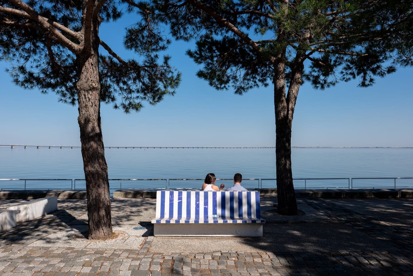 Relaxed romantic couple sitting together under shaded oak trees on an afternoon date in Round Rock, Texas