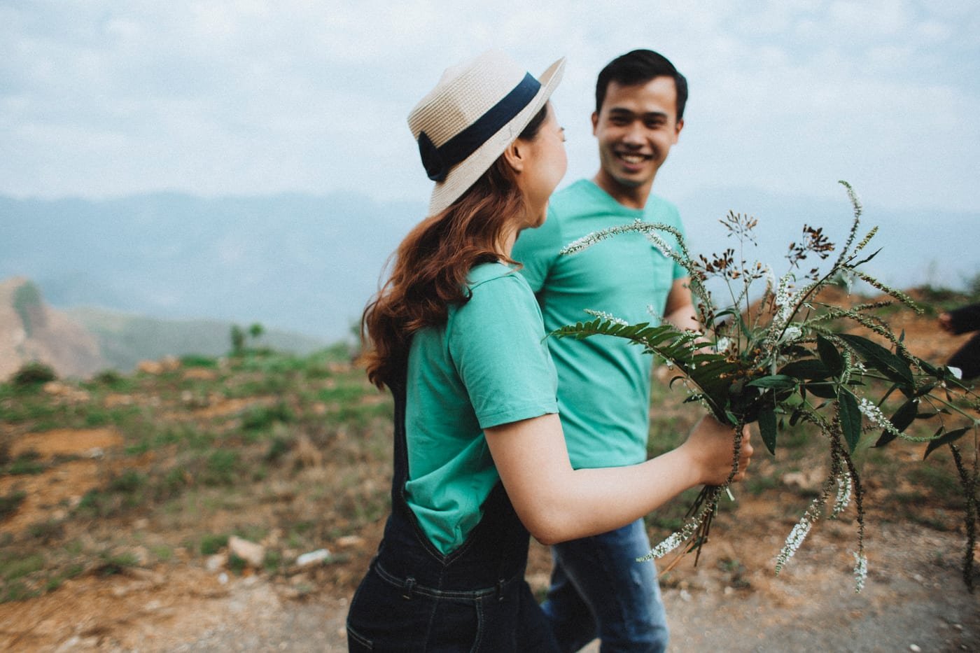 Happy romantic couple surrounded by blooming garden flowers in Tyler, Texas (The Rose Capital)