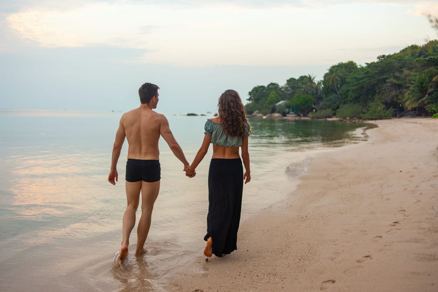 Joyful romantic couple walking hand-in-hand smiling with love, overcoming HSV stigma together